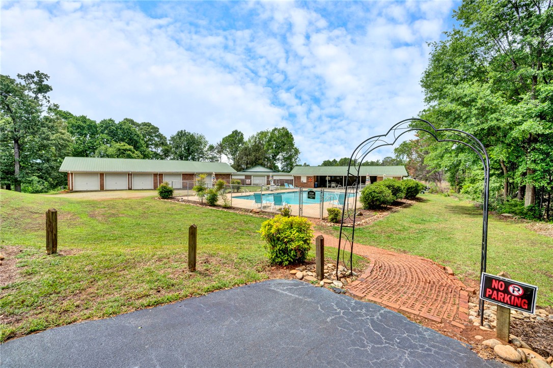 104 Captains Way Anderson, SC 29625 - Photo 25 of 47 Enjoy a refreshing dip in the outdoor pool, surrounded by lush greenery and ample parking.