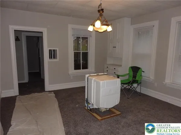 a living room with a couch and a chandelier