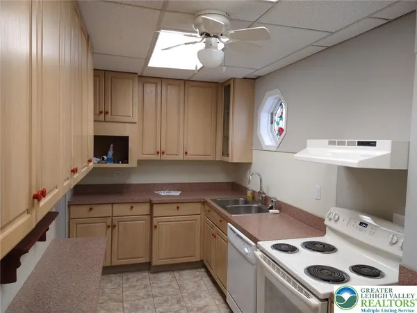 a kitchen that has a sink a stove and a microwave oven