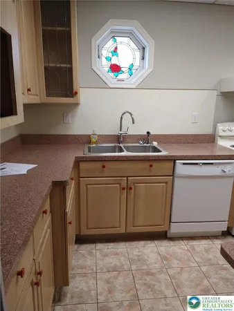 a kitchen with stainless steel appliances granite countertop a sink and a stove