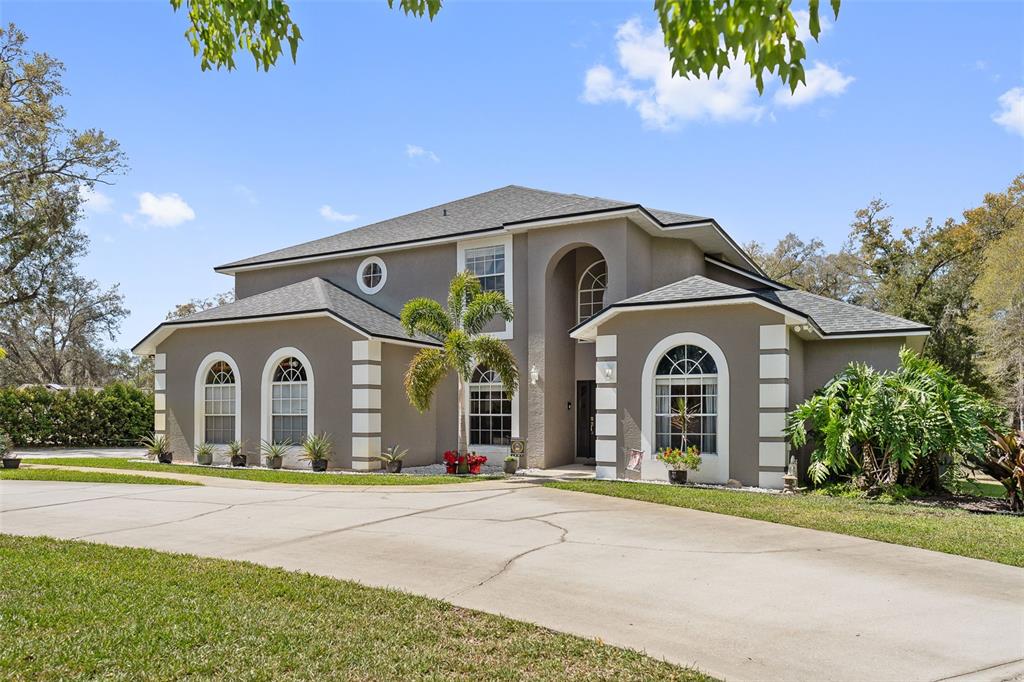 1810 Markham Woods Road Longwood, FL 32779 - Photo 1 of 1 a front view of a house with a garden