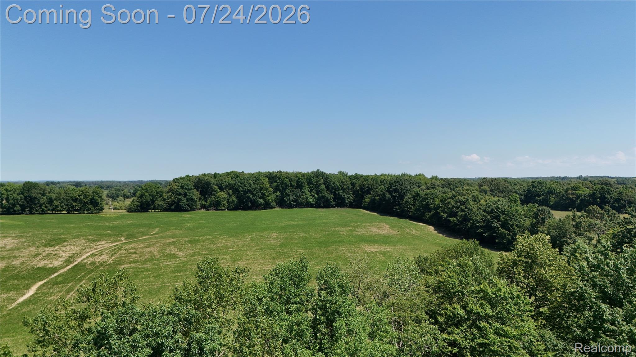 3226 Birch Run Road Millington, MI 48746 - Photo 23 of 27 Expansive green fields bordered by mature tree lines under a clear sky