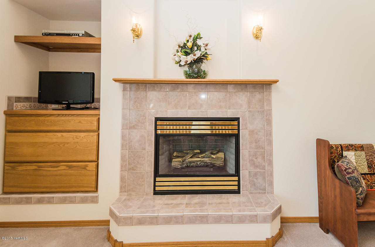 2971 Nelson Road Yakima, WA 98903 - Photo 16 of 43 a living room with a fireplace and a flat screen tv