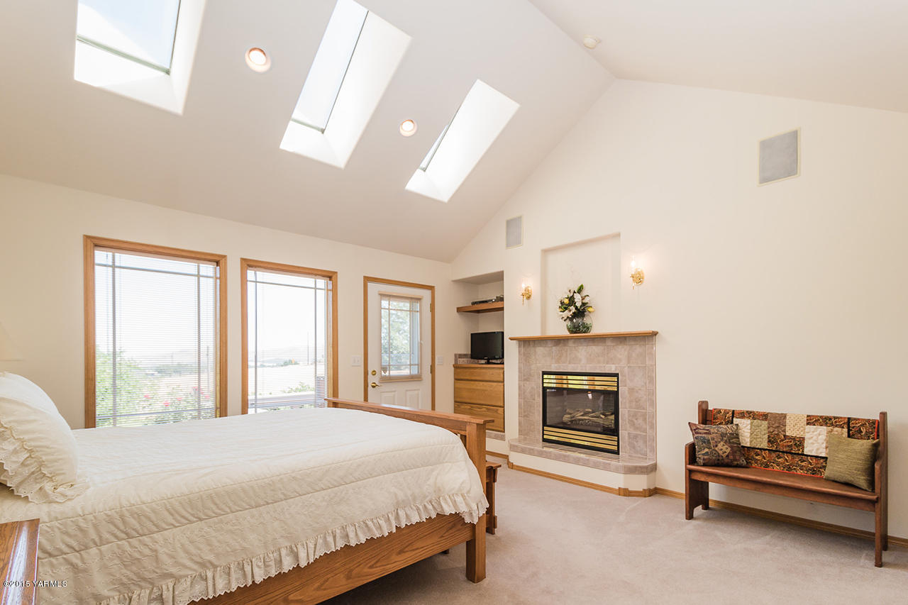 2971 Nelson Road Yakima, WA 98903 - Photo 17 of 43 a bedroom with a bed and a fireplace