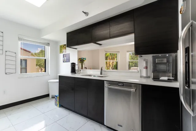 a kitchen with stainless steel appliances a sink stove and cabinets