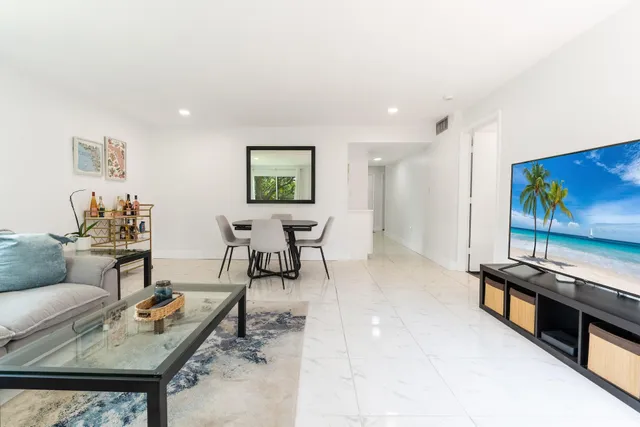 a living room with furniture and painting on the wall