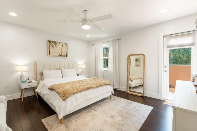 a bedroom with a large bed and a window