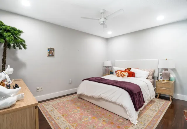 a bedroom with a bed and a potted plant