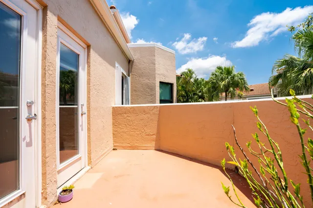 a sign of golf club on a wall under a tree