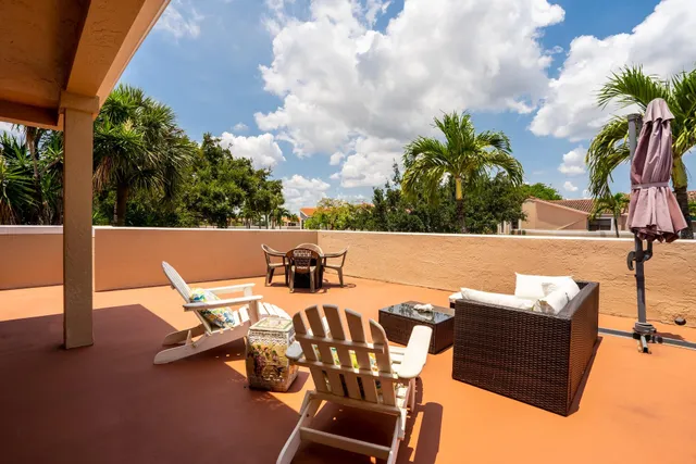 a view of an outdoor sitting area with furniture
