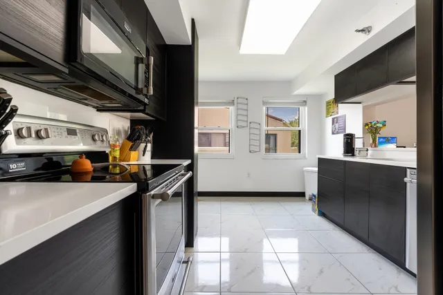 a kitchen with stainless steel appliances granite countertop a sink stove and cabinets