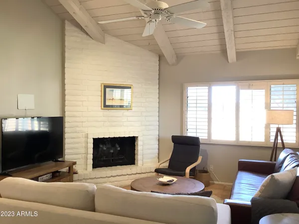 a kitchen with stainless steel appliances a table chairs microwave and refrigerator