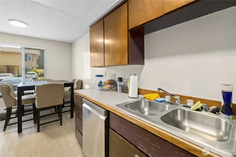 a kitchen with a sink cabinets and dining table