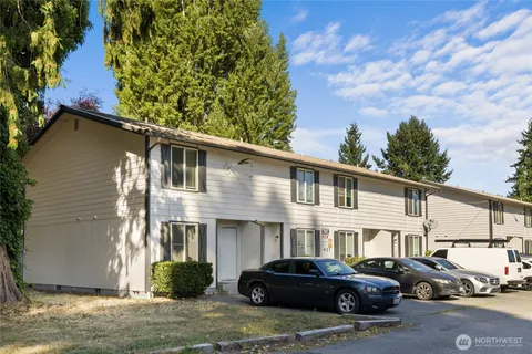 a car parked in front of a white house