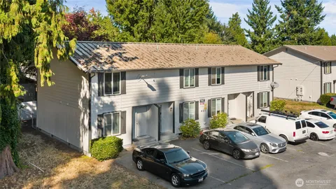 a car parked in front of a white house