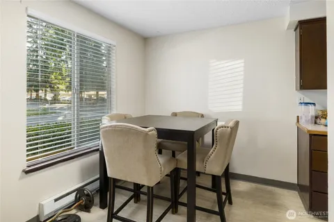a view of a dining room with furniture and a window
