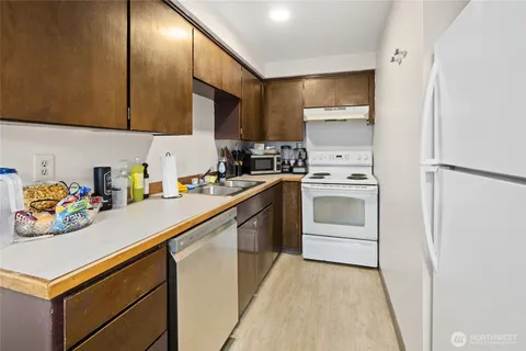 a kitchen with white cabinets and white appliances