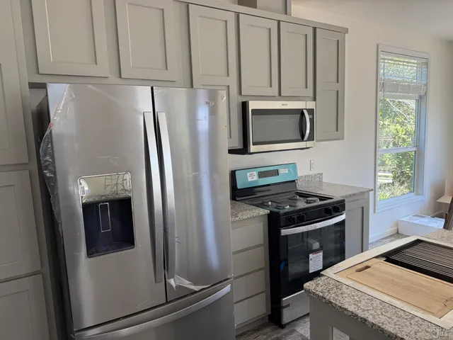 a kitchen with a stove and a microwave