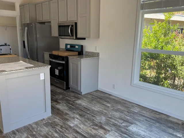 a view of a kitchen with electric appliances