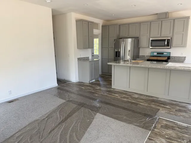 a view of a room with wooden floor and a bed
