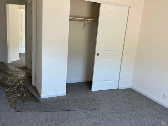 an empty room with closet area