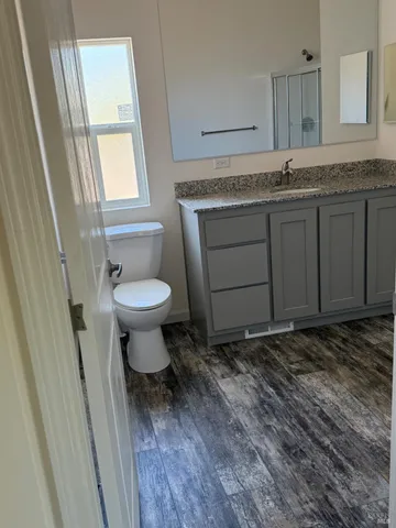 an empty room with windows and closet