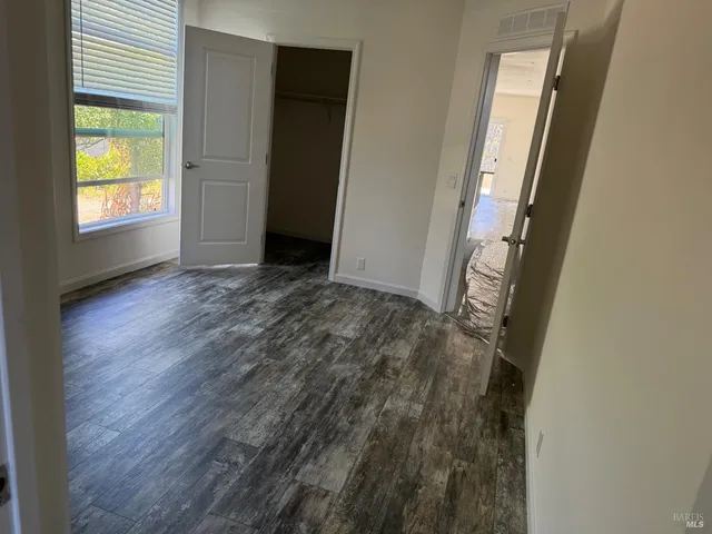 a view of hallway with wooden floor