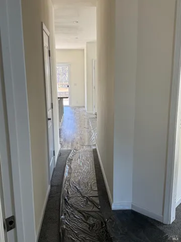 a view of house with a big yard and large trees