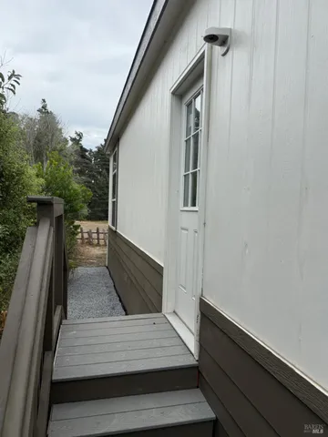 a view of backyard of house and car parked