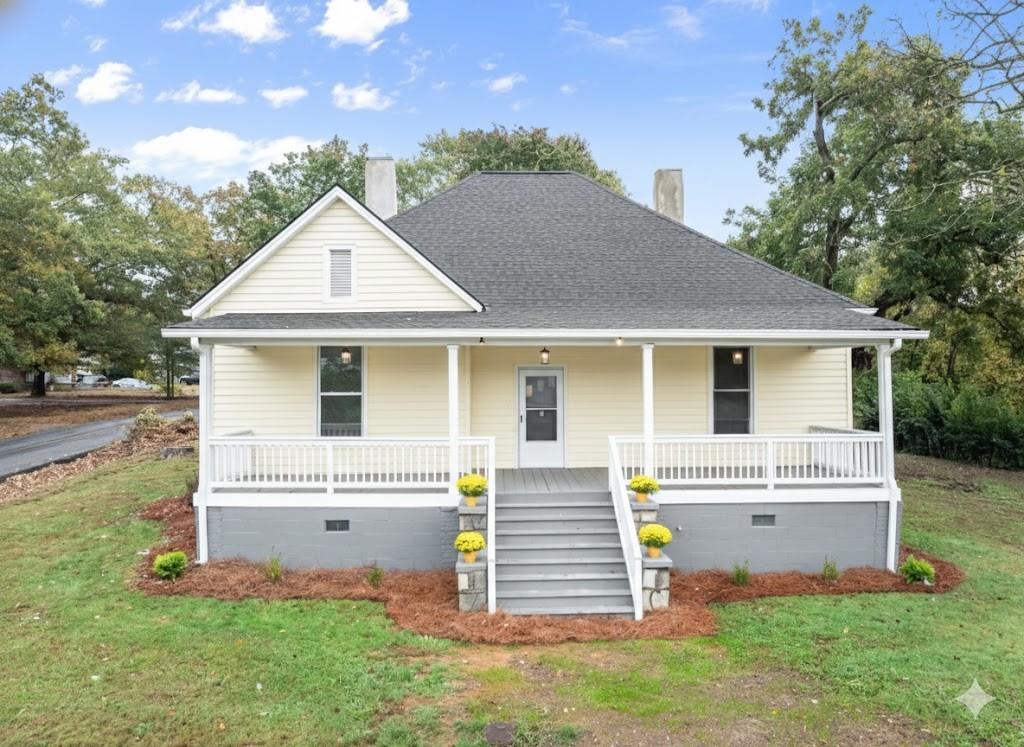a front view of a house with a garden and plants
