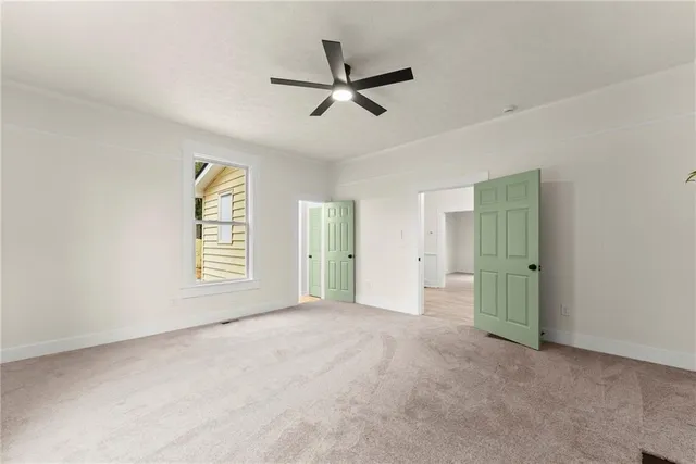 a view of a livingroom with a ceiling fan and window