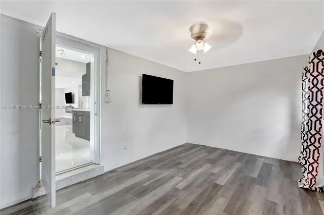 a living room filled with furniture and a potted plant