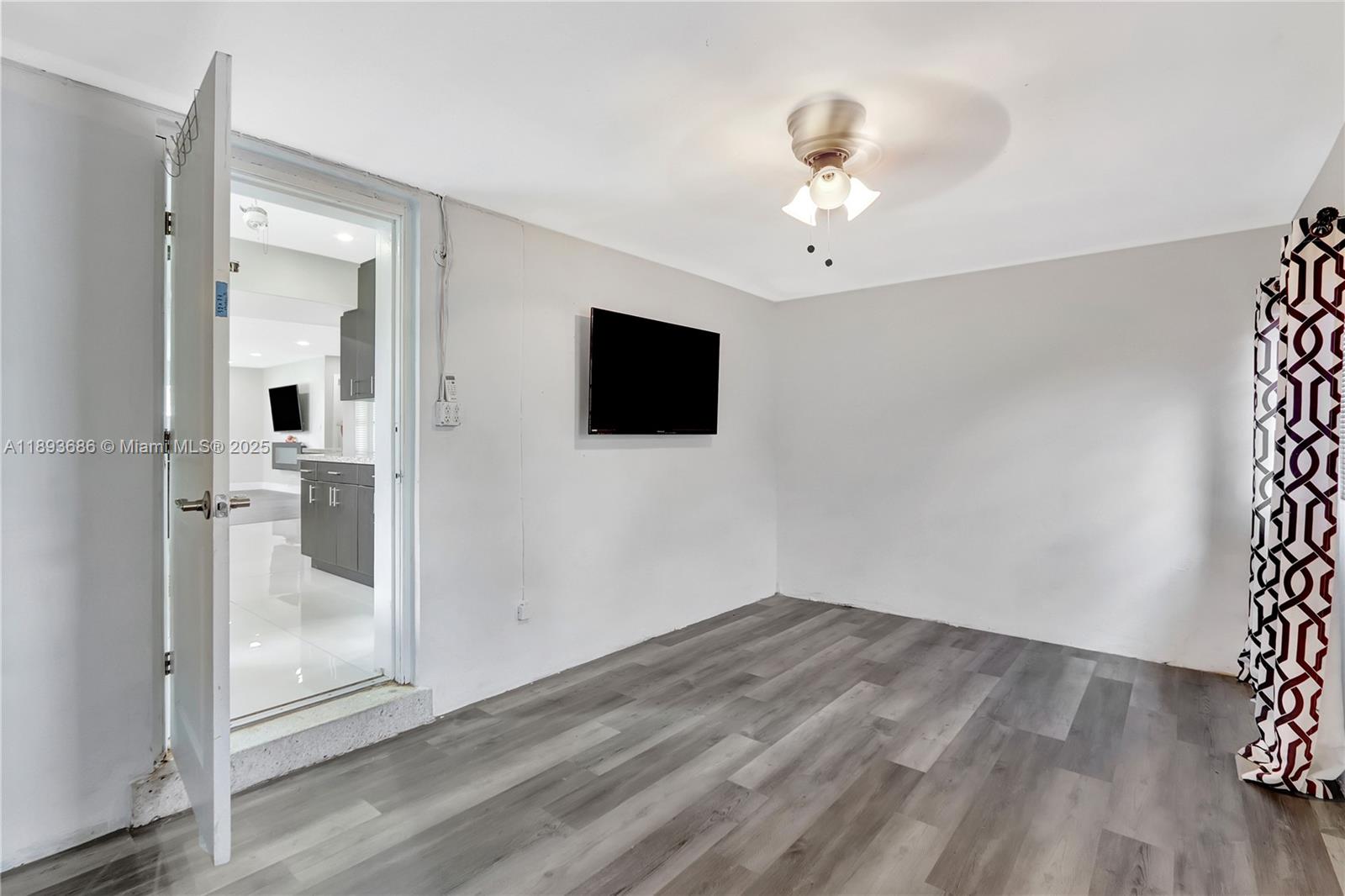 820 Northwest 67th Avenue Margate, FL 33063 - Photo 12 of 17 a view of a livingroom with wooden floor and a flat screen tv