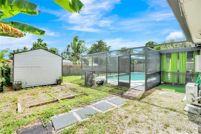 a backyard of a house with table and chairs