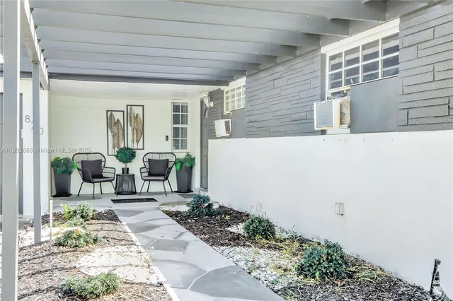 a living room with furniture and large wooden floor