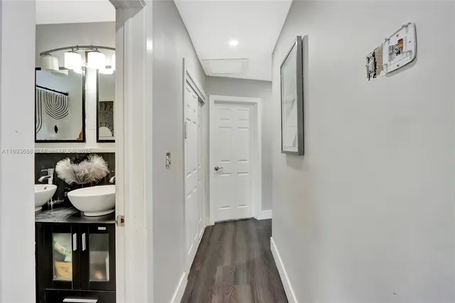 a bathroom with a sink a toilet a mirror and shower