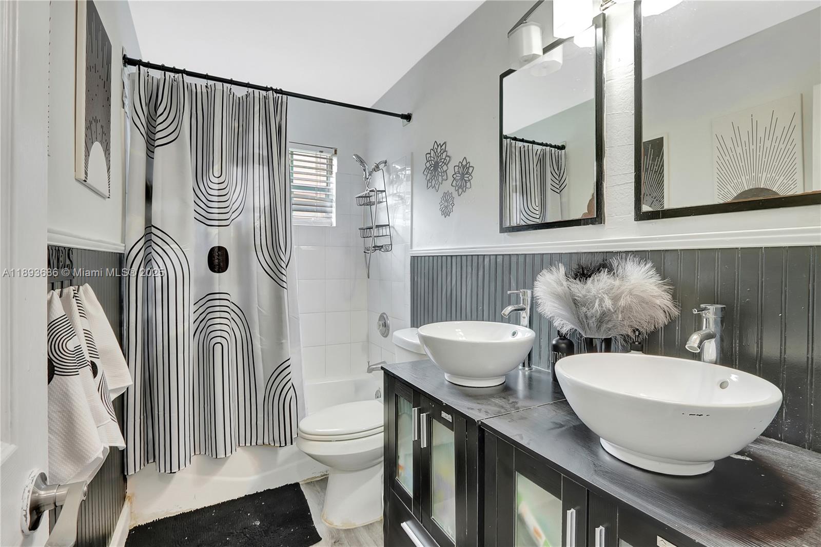 820 Northwest 67th Avenue Margate, FL 33063 - Photo 8 of 17 a bathroom with a sink a toilet a mirror and shower