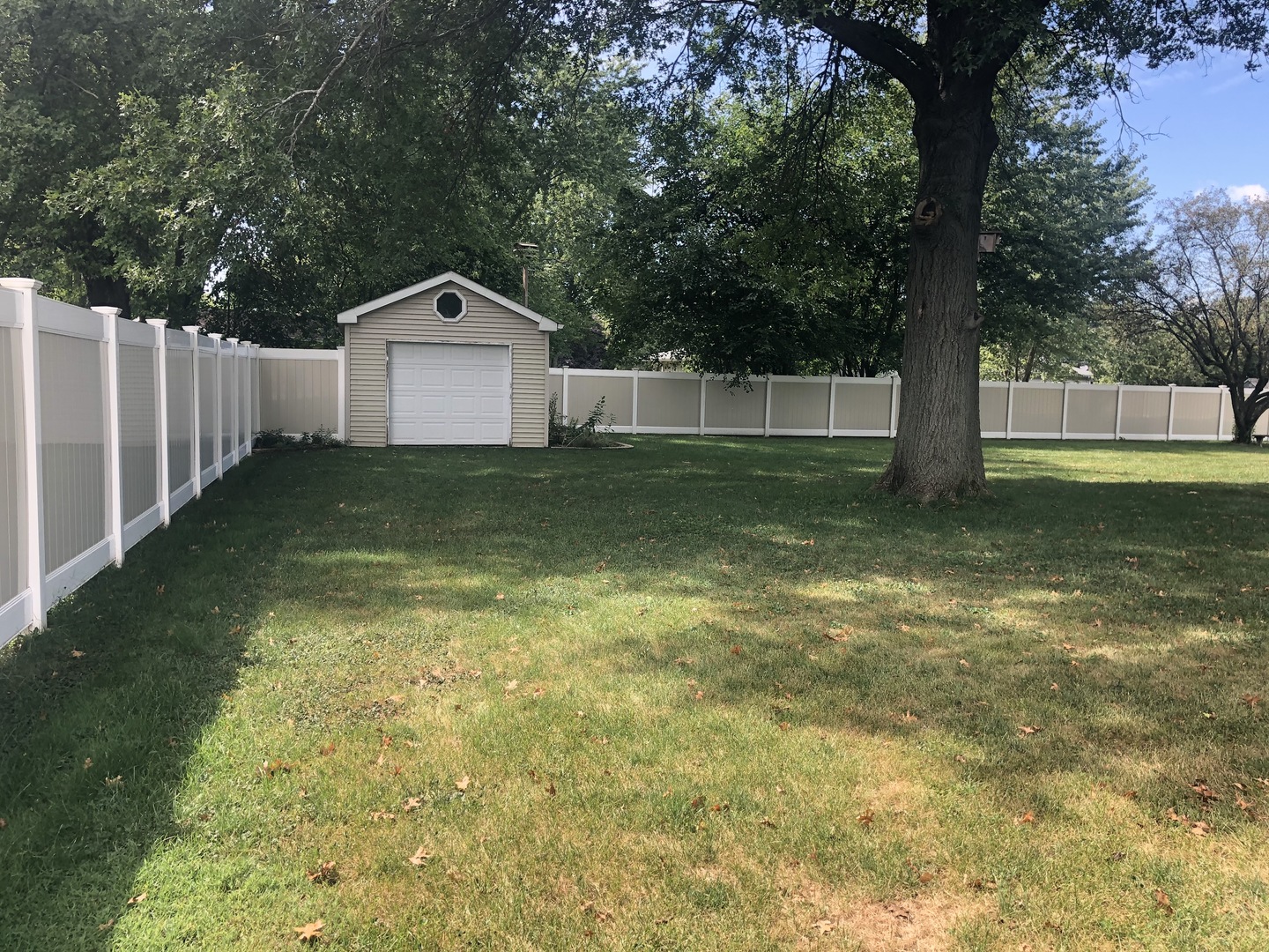 24848 South Ridge Road Elwood, IL 60421 - Photo 11 of 48 a backyard of a house with large trees and wooden fence