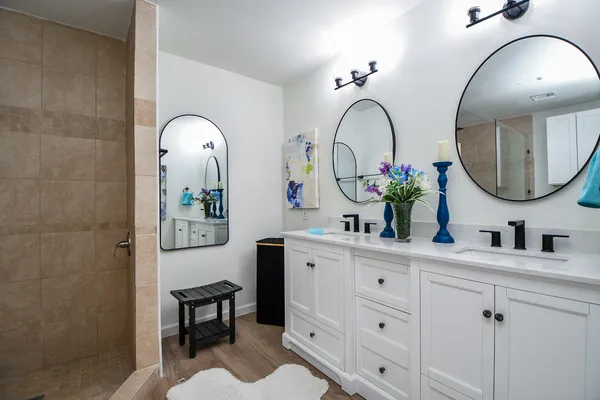 a bathroom with a double vanity sink and a mirror