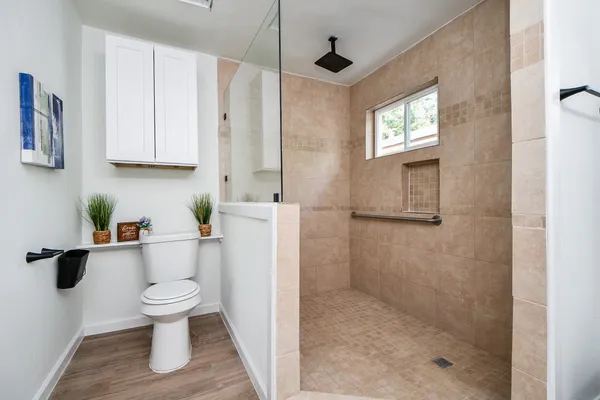 a bathroom with a toilet a sink and a shower