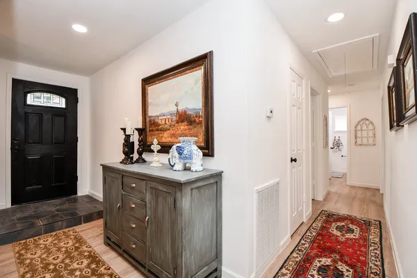 a view of room with painting on the wall and a rug