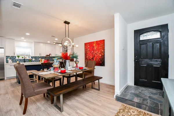 a dining room filled with furniture and wooden floor