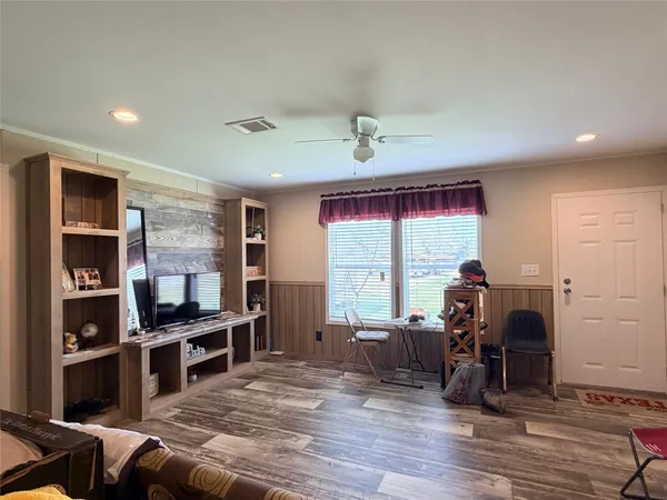 a view of a livingroom with furniture window and wooden floor