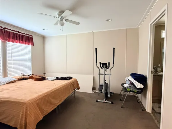 a bedroom with bed and a window