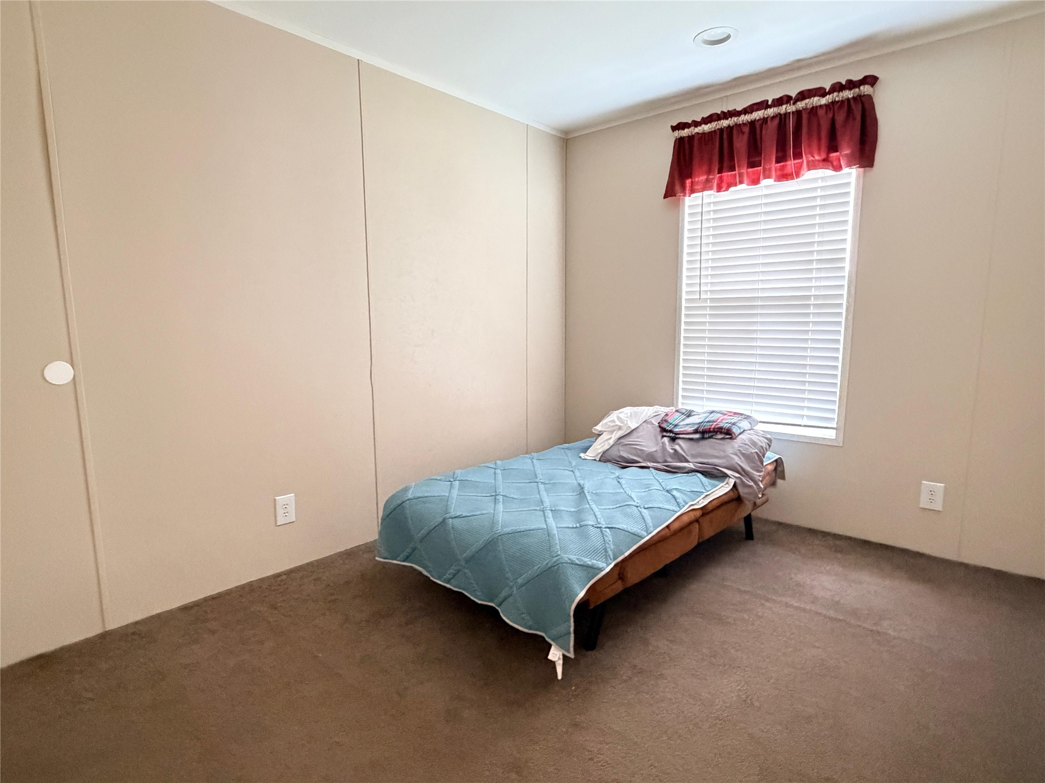 13700 Burnett Road Beasley, TX 77417 - Photo 6 of 38 a bed sitting in a bedroom next to a window