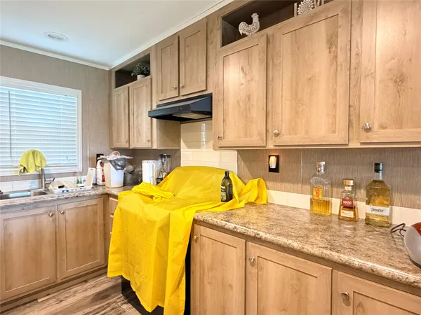 a kitchen with a sink a stove and cabinets