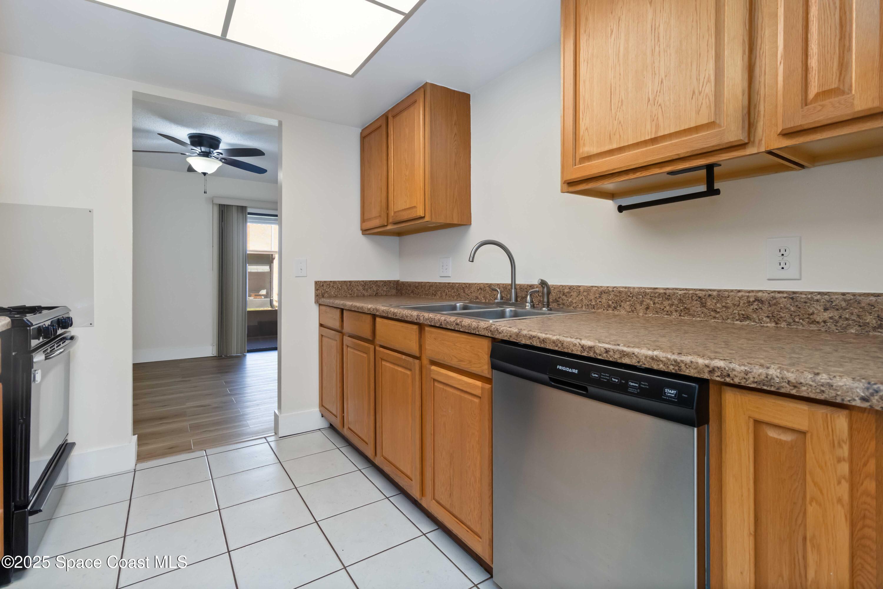 182 Bluefish Place, Unit 710 Rockledge, FL 32955 - Photo 15 of 33 a kitchen with stainless steel appliances granite countertop a sink and cabinets