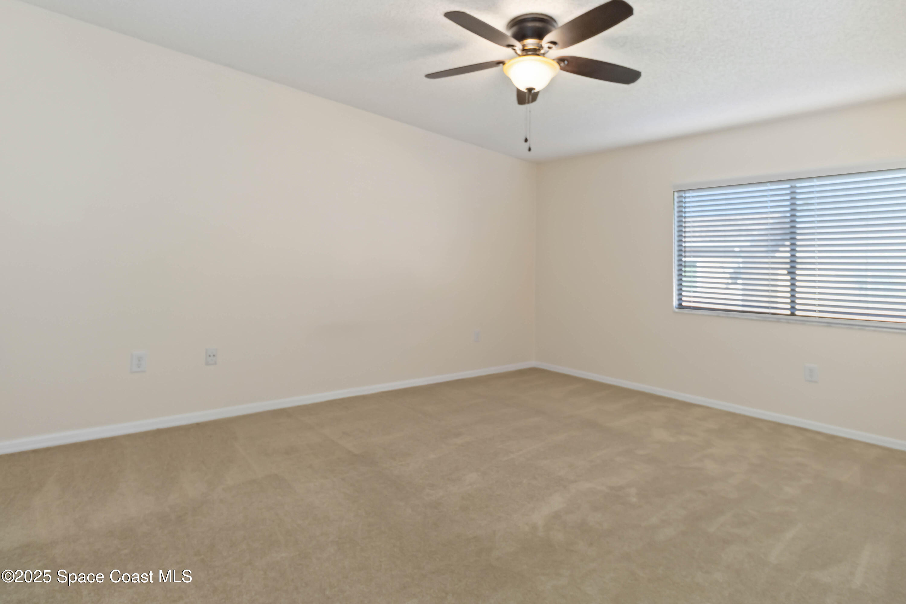 182 Bluefish Place, Unit 710 Rockledge, FL 32955 - Photo 19 of 33 an empty room with a window and a fan