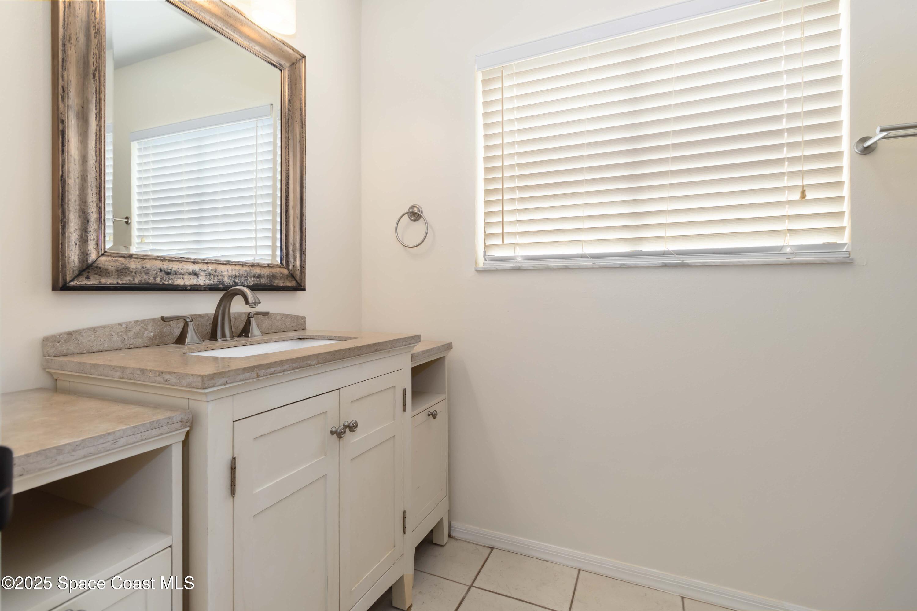 182 Bluefish Place, Unit 710 Rockledge, FL 32955 - Photo 22 of 33 a bathroom with a sink and a vanity