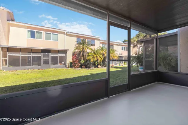 a view of an empty room with wooden floor and a bathtub